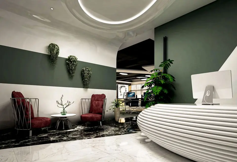 Elegant reception area featuring modern decor with burgundy chairs and greenery in Casablanca, Morocco.